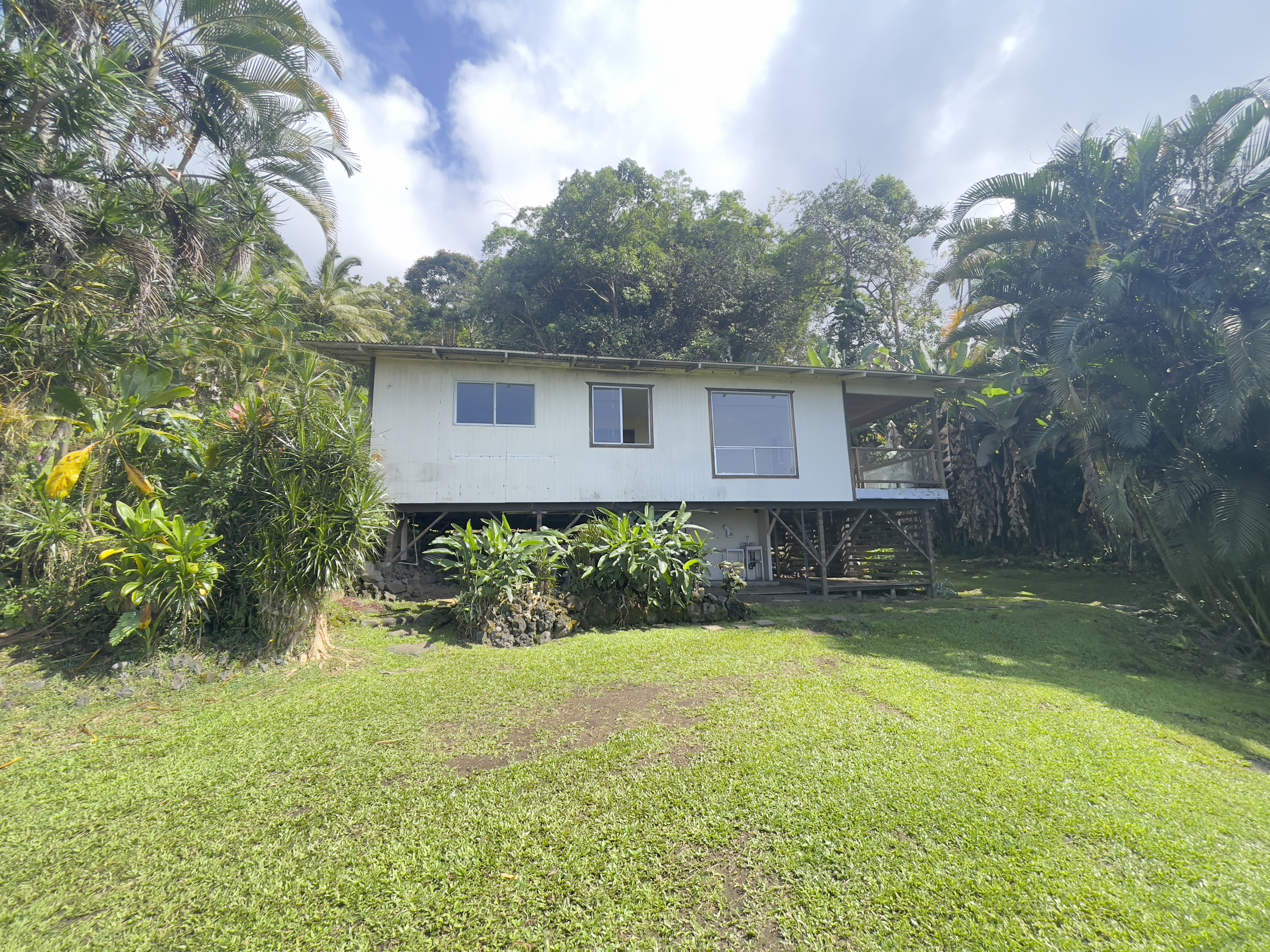 83-5586 Hawaiʻi Belt Road Captain Cook, HI 96704 - Photo 4 of 23 a view of house with a yard and potted plants
