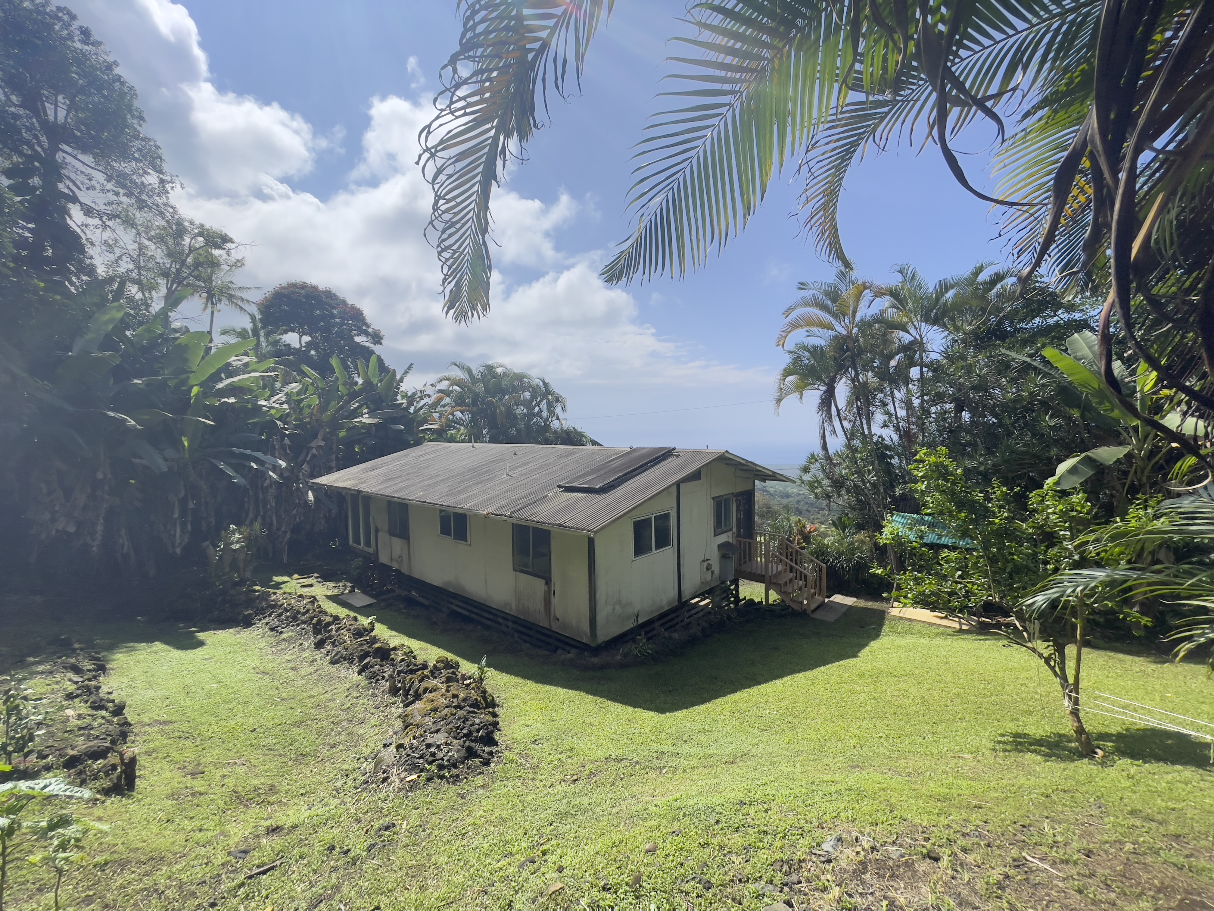 83-5586 Hawaiʻi Belt Road Captain Cook, HI 96704 - Photo 8 of 23 a view of a backyard with plants