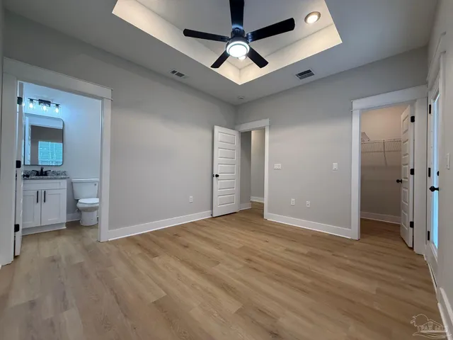 a bathroom with a granite countertop toilet sink and mirror