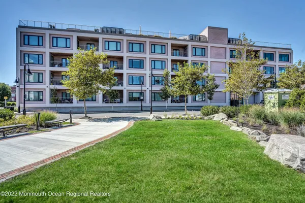 a house view with outdoor seating space and garden