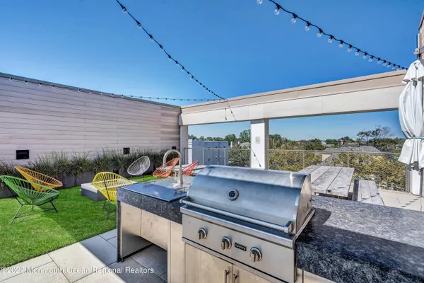a view of a backyard with plants and patio