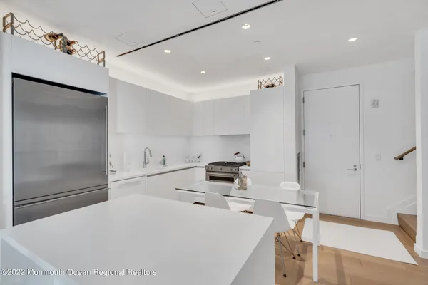 a kitchen with a sink a stove and chairs