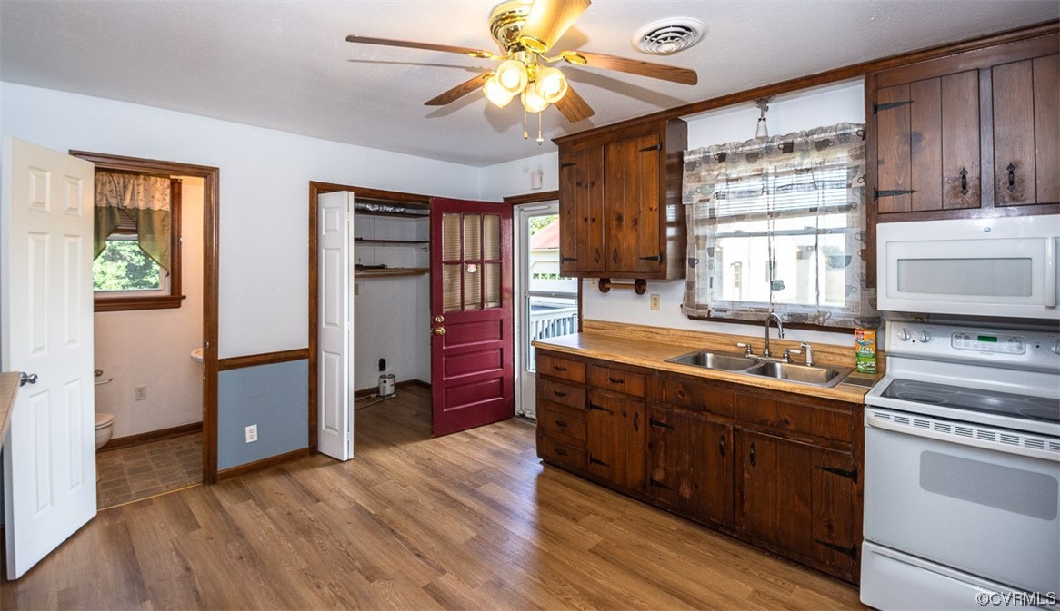 8409 Buffin Road Henrico, VA 23231 - Photo 11 of 22 a kitchen with stainless steel appliances granite countertop a refrigerator a sink dishwasher a stove and white countertops with wooden floor