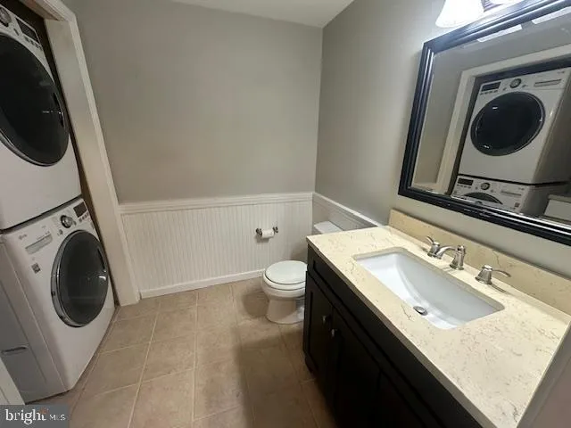 a bathroom with a granite countertop sink a mirror and a bathtub