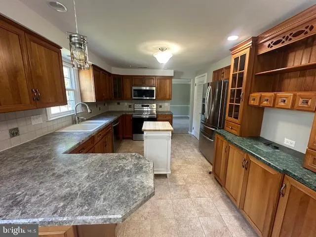 a view of an empty room with window and hallway