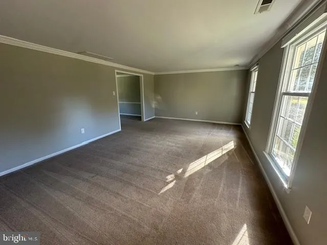a view of a room with windows and chandelier