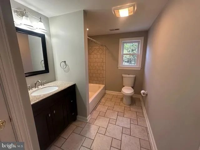 a bathroom with a sink a washer and dryer