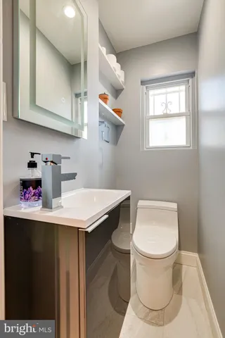 a kitchen with stainless steel appliances a sink a stove and cabinets