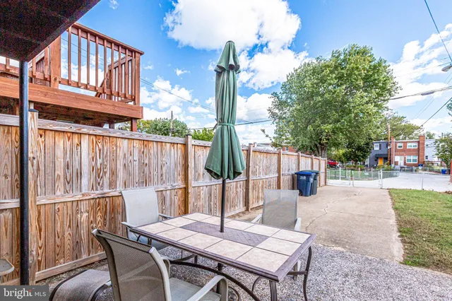 a view of a patio with a table and chairs