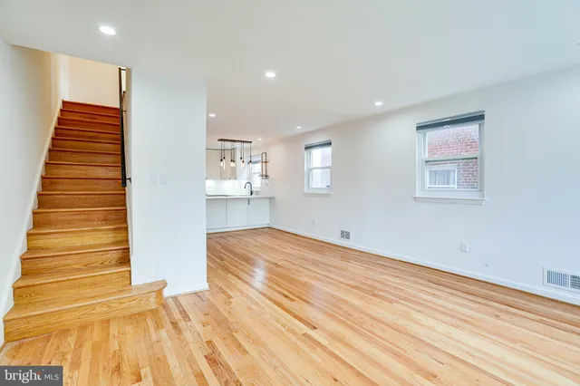 a view of empty room with wooden floor