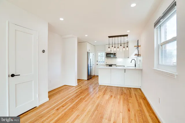 a view of kitchen with wooden floor and electronic appliances