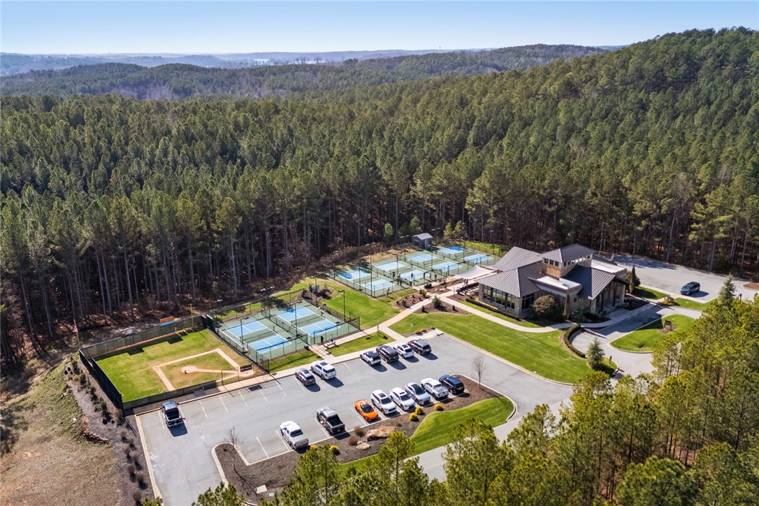 130 River Ridge Road Sunset, SC 29685 - Photo 46 of 47 An aerial perspective reveals a serene community complex nestled among verdant woodlands, featuring recreational courts and a clubhouse.
