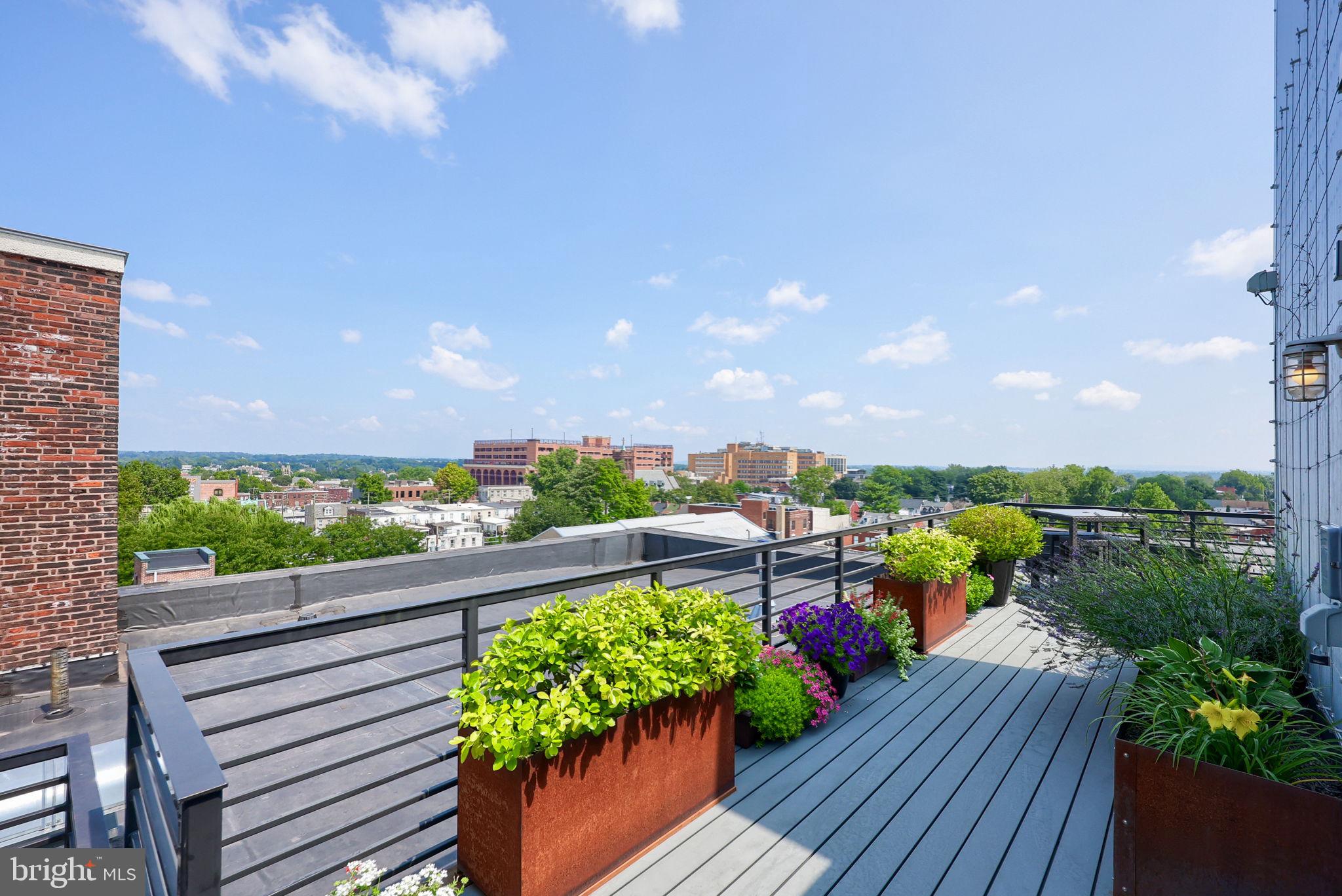 41 West Lemon Street, Unit 210 Lancaster, PA 17603 - Photo 41 of 43 a view of a balcony with wooden benches and a garden