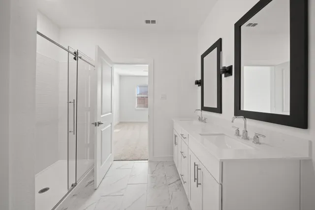 a bathroom with a double vanity sink and mirror