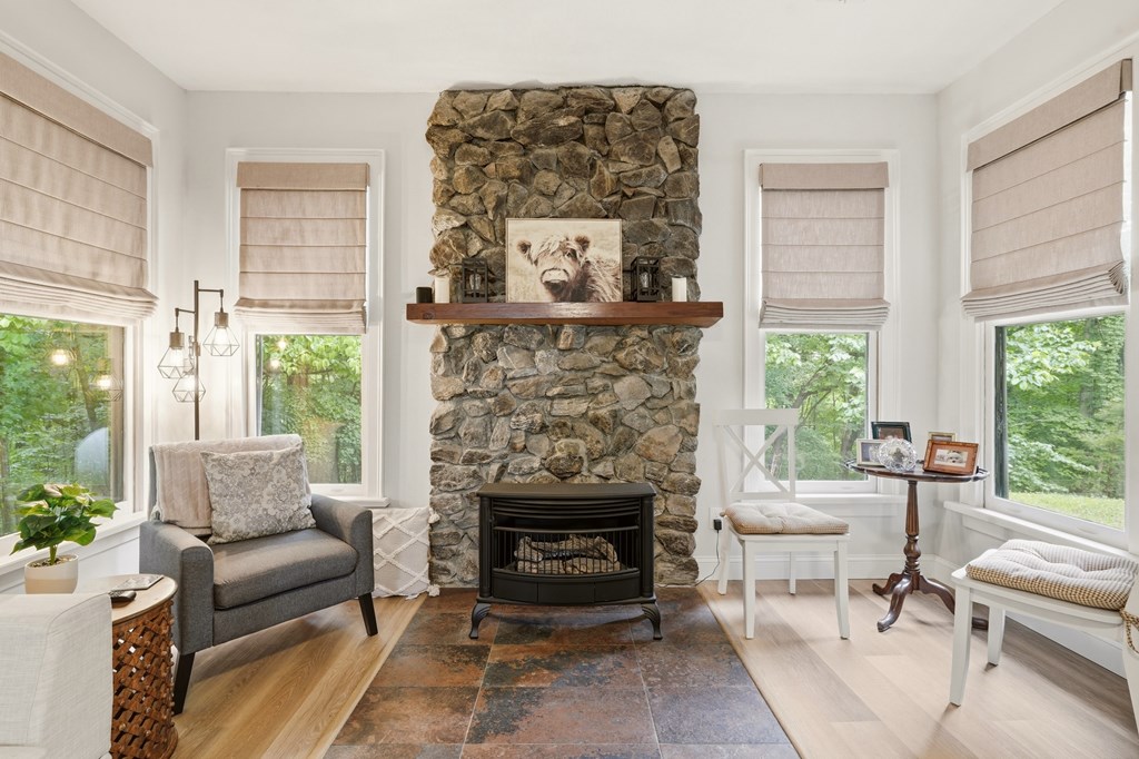 175 Crane Creek Road Young Harris, GA 30582 - Photo 10 of 40 a living room with furniture a window and a fireplace