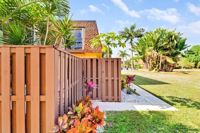 a view of small yard with wooden fence