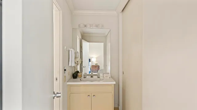a bathroom with a sink a mirror and vanity