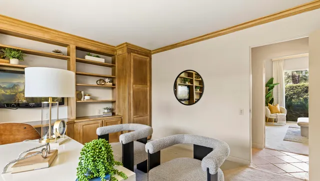 a living room with couches a large mirror with wooden floor