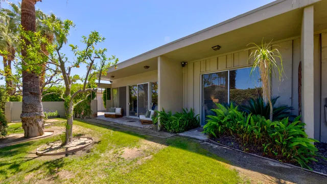 a view of a house with pool and sitting area
