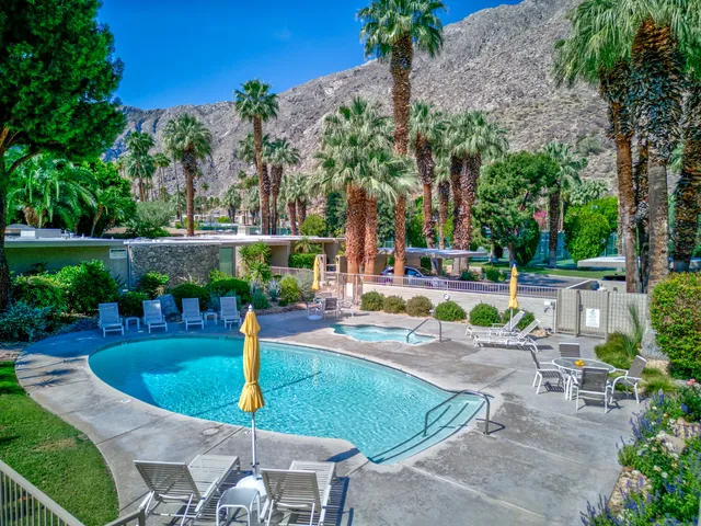 a view of a backyard with swimming pool