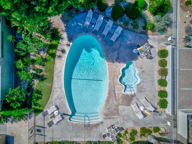 an aerial view of a house with garden space and trees