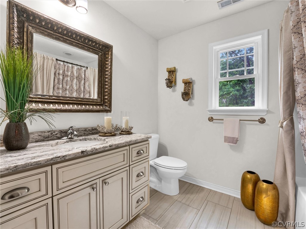 3249 Ludgate Road Chester, VA 23831 - Photo 23 of 34 a bathroom with a granite countertop toilet sink and mirror