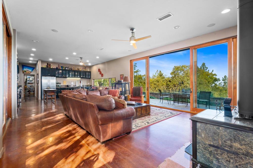 a living room with furniture a rug and a large window