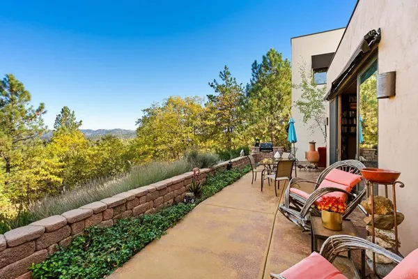 a view of a patio with table and chairs and potted plants