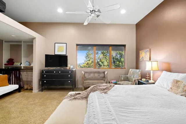 a bedroom with a bed gym equipment and a window