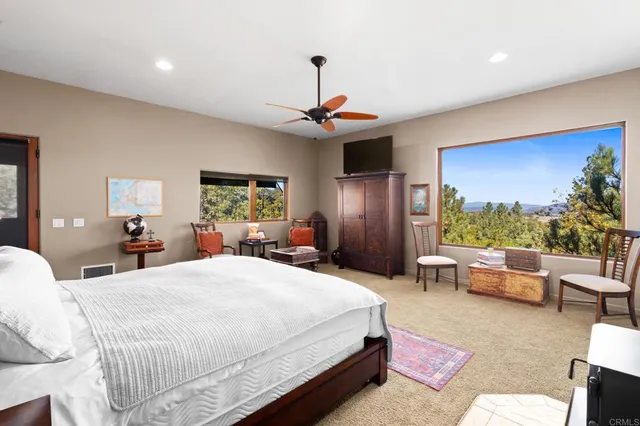a view of a hallway with wooden floor and windows