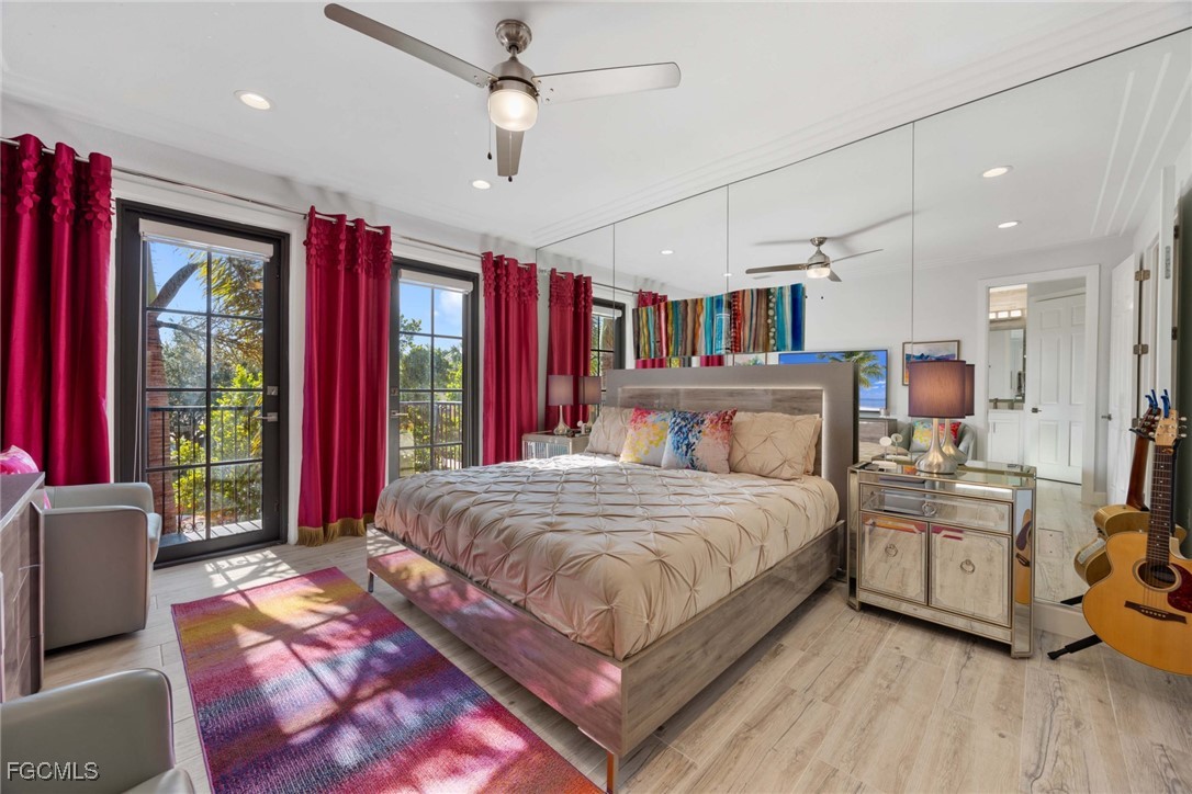 9111 Capistrano Street South, Unit 8302 Naples, FL 34113 - Photo 13 of 40 a bedroom with a large bed a flat tv screen and dresser