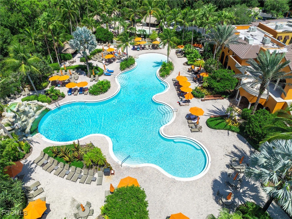 9111 Capistrano Street South, Unit 8302 Naples, FL 34113 - Photo 29 of 40 an aerial view of a swimming pool a yard and mountain view in back