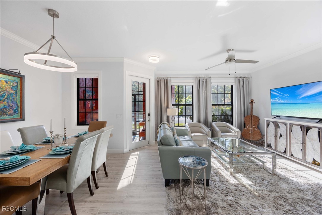 9111 Capistrano Street South, Unit 8302 Naples, FL 34113 - Photo 3 of 40 a living room with furniture a window and a table