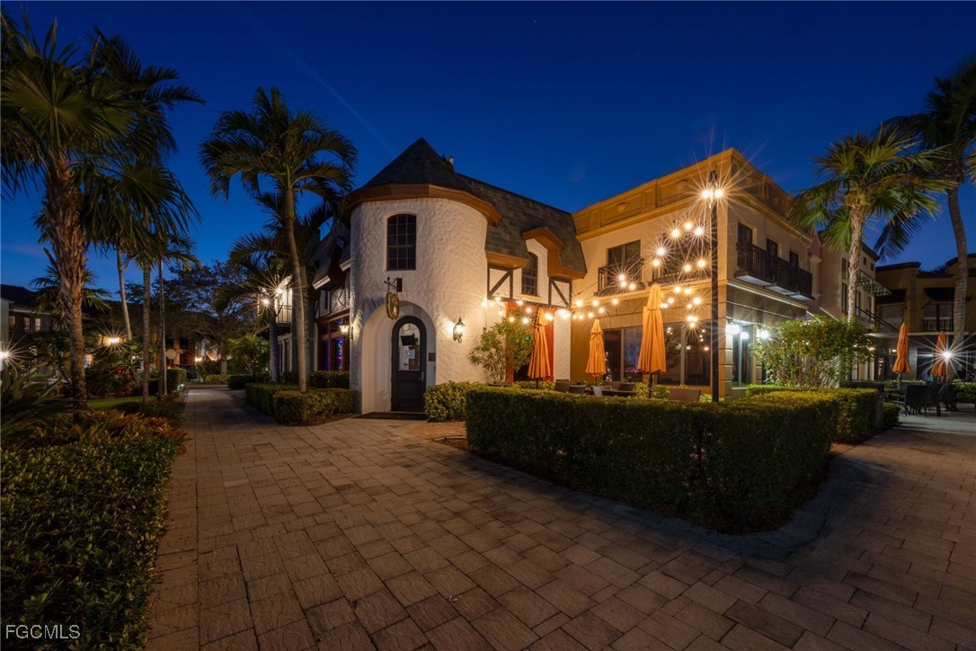 9111 Capistrano Street South, Unit 8302 Naples, FL 34113 - Photo 32 of 40 a view of a house with a yard