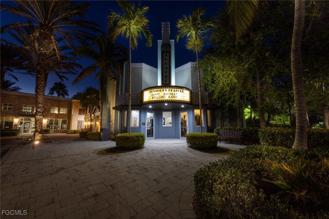 9111 Capistrano Street South, Unit 8302 Naples, FL 34113 - Photo 38 of 40 a view of a patio with table and chairs potted plants and palm trees