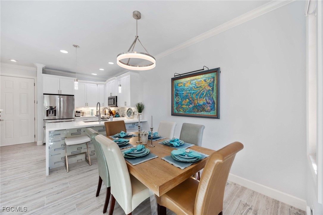 9111 Capistrano Street South, Unit 8302 Naples, FL 34113 - Photo 7 of 40 a view of a dining room with furniture