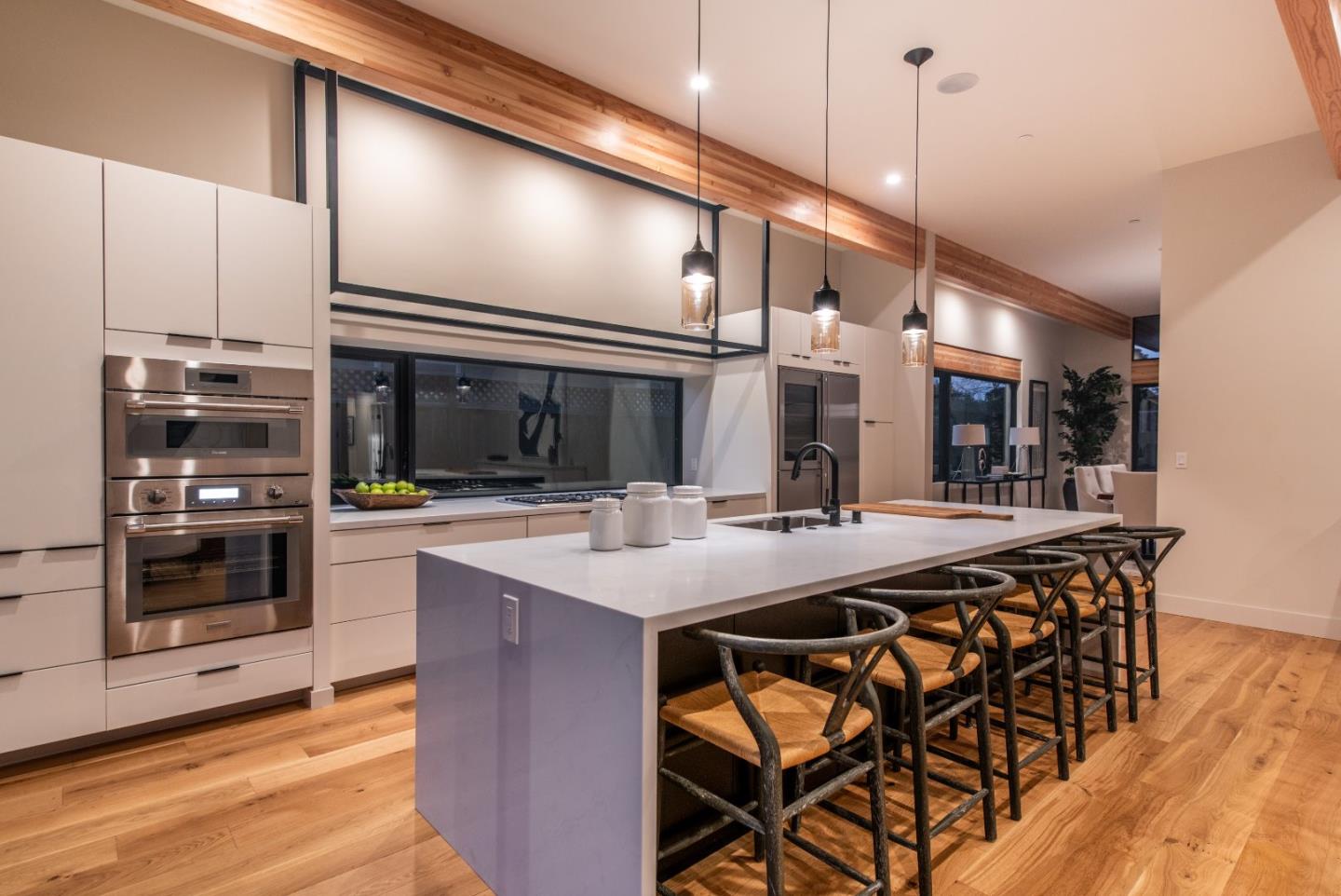 667 Springer Terrace Los Altos, CA 94024 - Photo 15 of 36 a kitchen with stainless steel appliances kitchen island a large island in the center and cabinets
