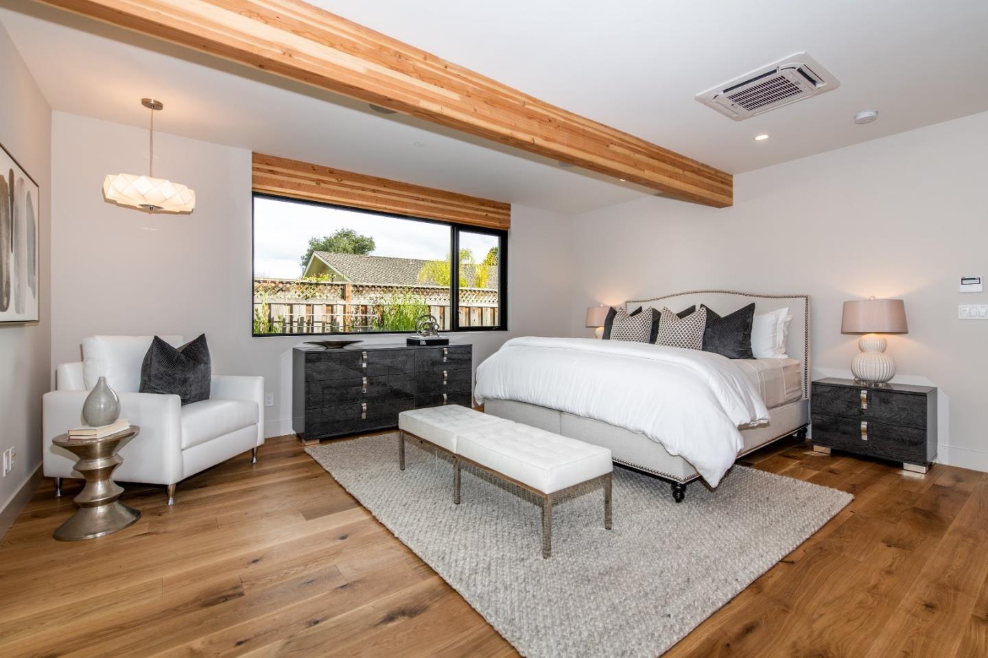 667 Springer Terrace Los Altos, CA 94024 - Photo 20 of 36 a spacious bedroom with a bed and a couch