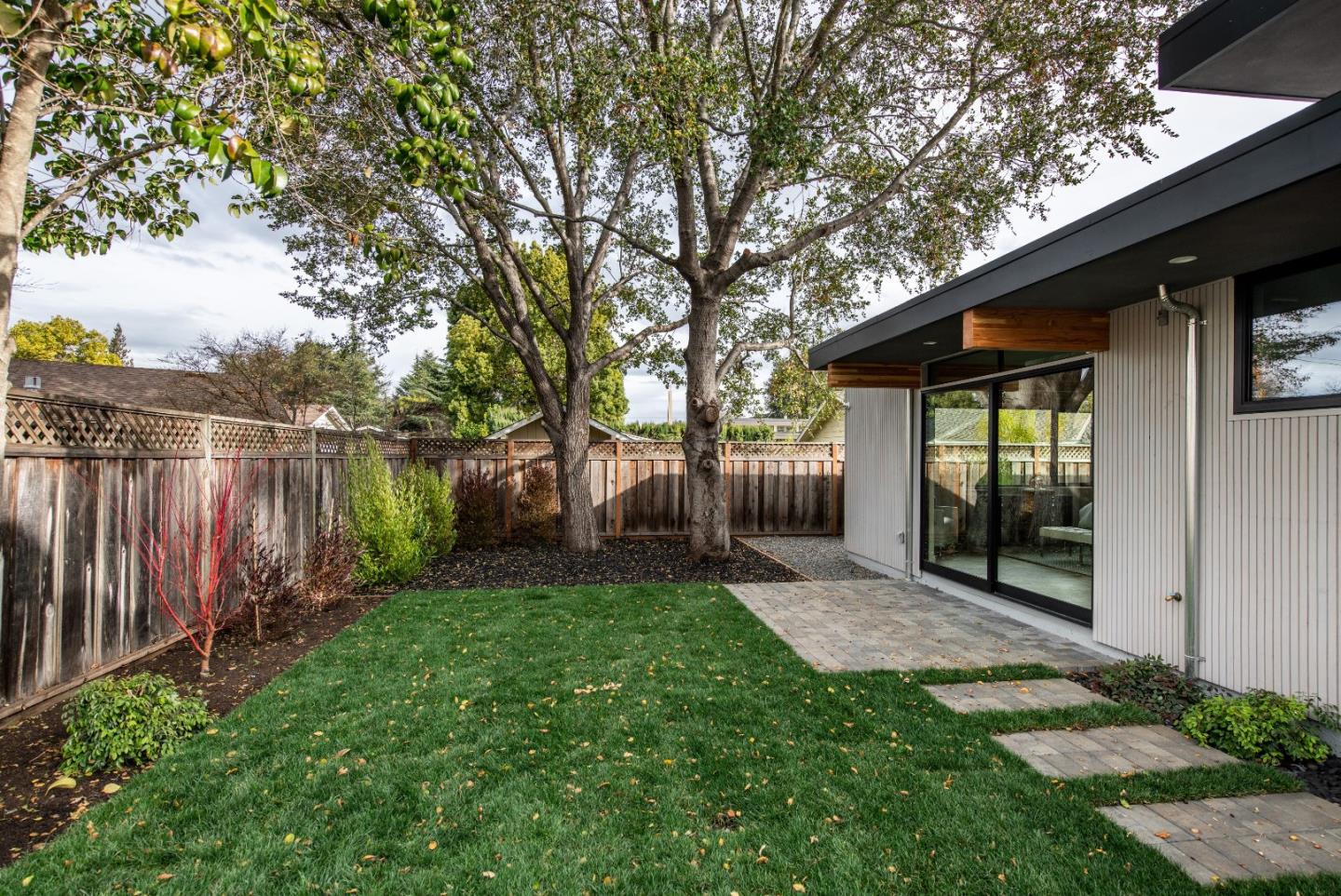 667 Springer Terrace Los Altos, CA 94024 - Photo 34 of 36 a view of a backyard with large trees and wooden fence