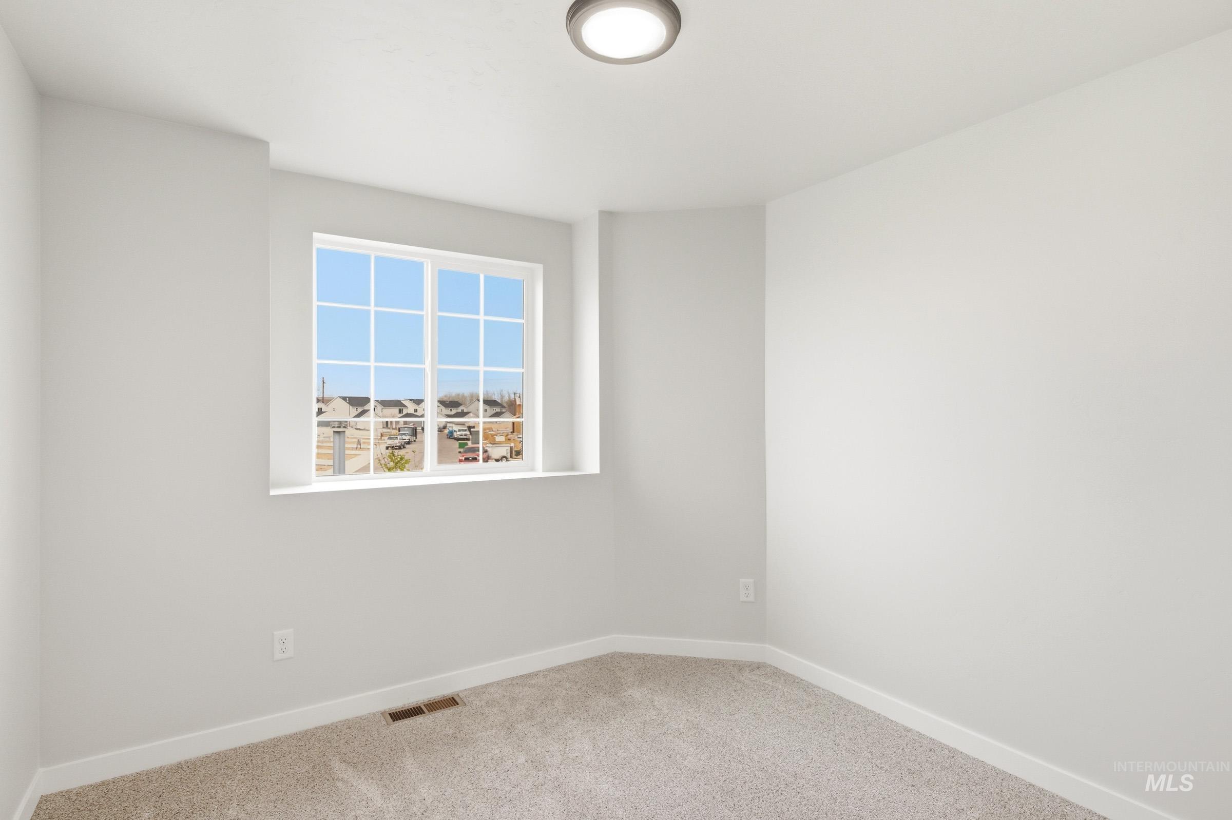 2446 West Fallon Loop Nampa, ID 83651 - Photo 11 of 19 Unfurnished room featuring light colored carpet and baseboards