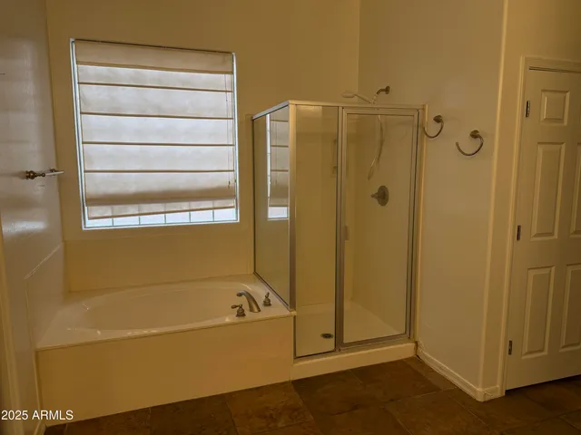a bathroom with a bathtub and shower