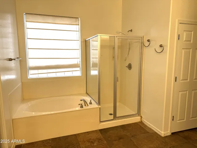 a bathroom with a bathtub and a shower