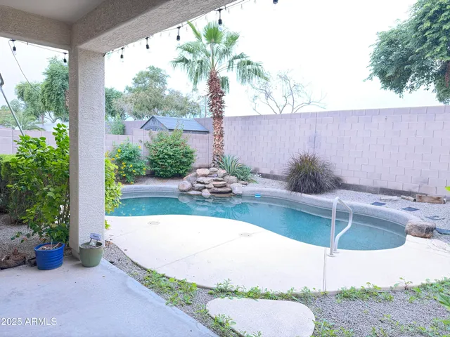 a view of a swimming pool with a patio
