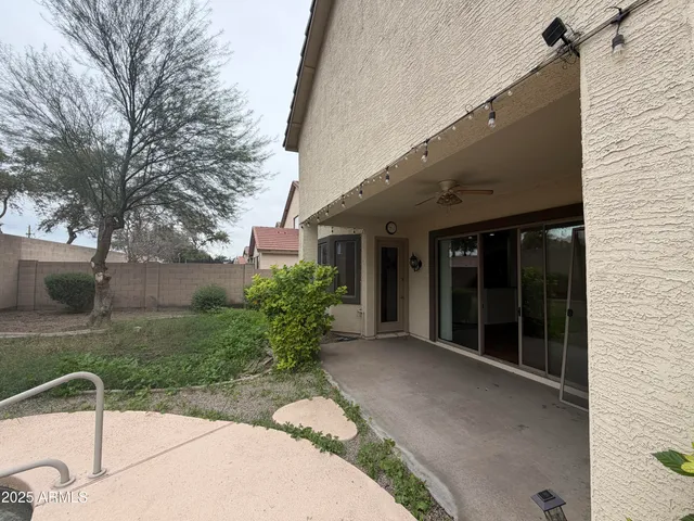 a view of a patio with table and chairs and potted plants