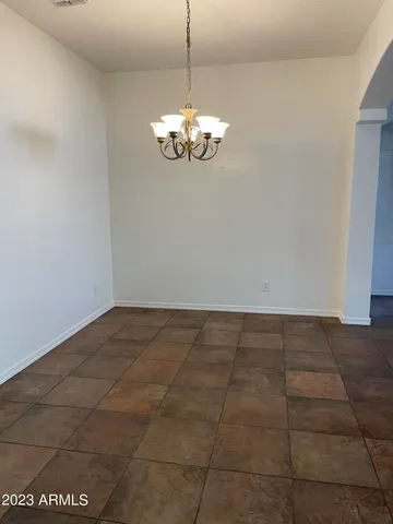 a view of a chandelier fan in the room