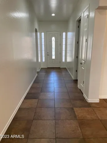 a view of a hallway with wooden doors