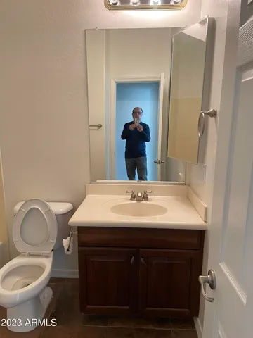 a bathroom with a sink toilet and mirror