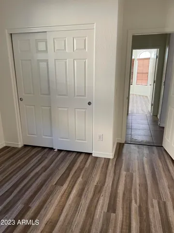 a view of a room with wooden floor and entryway