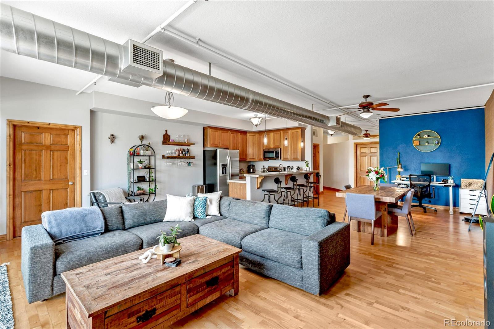 3299 Lowell Boulevard, Unit 302 Denver, CO 80211 - Photo 11 of 50 a living room with furniture and wooden floor