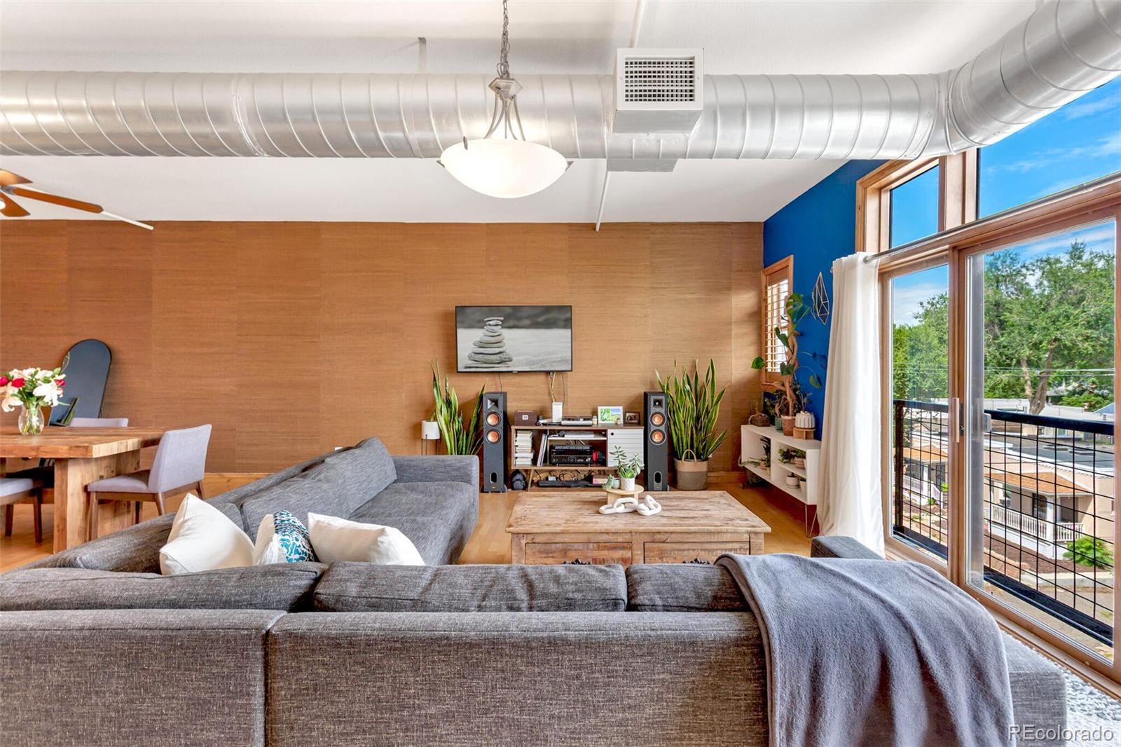 3299 Lowell Boulevard, Unit 302 Denver, CO 80211 - Photo 13 of 50 a living room with furniture kitchen view and a large window